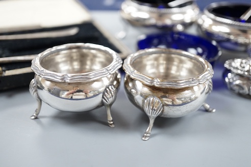 A pair of Victorian silver bun salts with blue glass liners and spoons, a spare liner, a later pair of small silver salts, a silver pepperette, a small silver box and a silver christening pair in box for three.